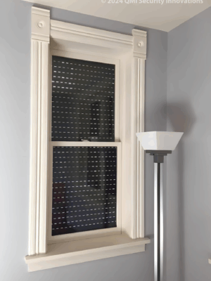 Security shutter style roll-up door installed over a window