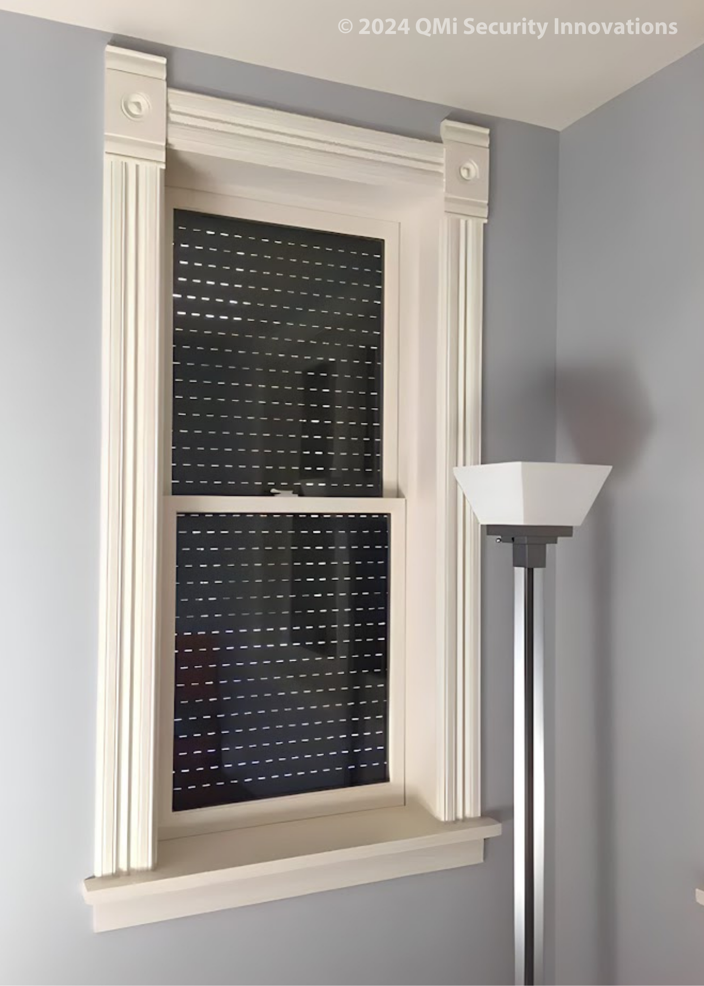 Security shutter style roll-up door installed over a window