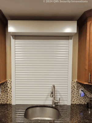 Security shutter style roll-up door installed behind a sink