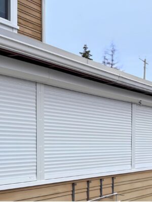 Security shutter style roll-up door installed on the outside of a building.