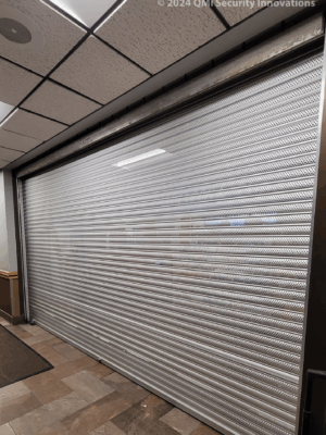 Security shutter style roll-up door lifted in a position to see through