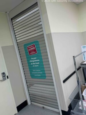 Security shutter style roll-up door installed in a doorway, lifted into a view through position