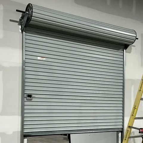 roll-up door installed on a warehouse divide wall, interior